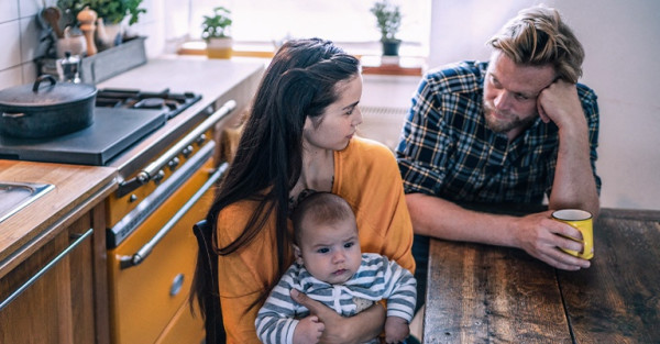 A couple with a baby reflecting on their relationship